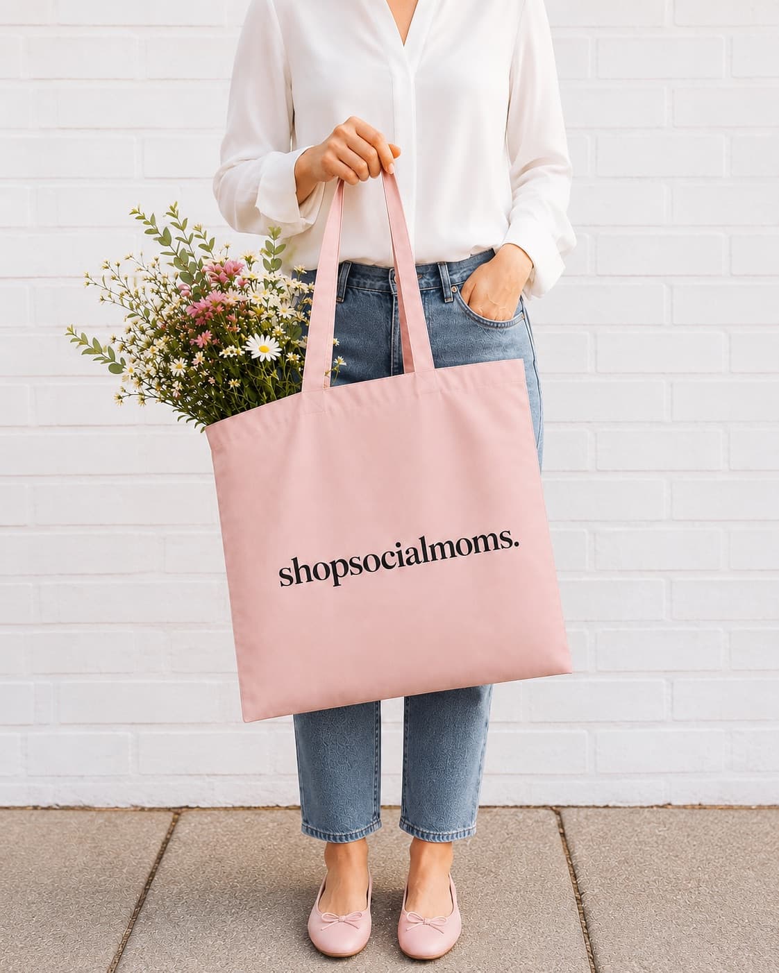 A shopsocialmoms. tote bag, carried, with flowers in it